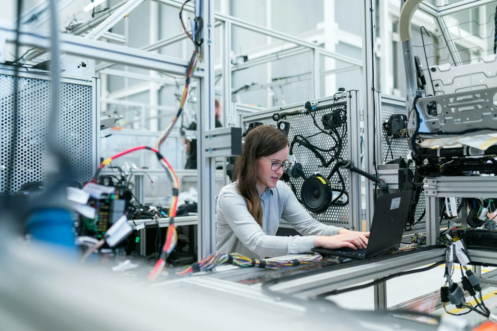 An engineer working at a bench with technical equipment